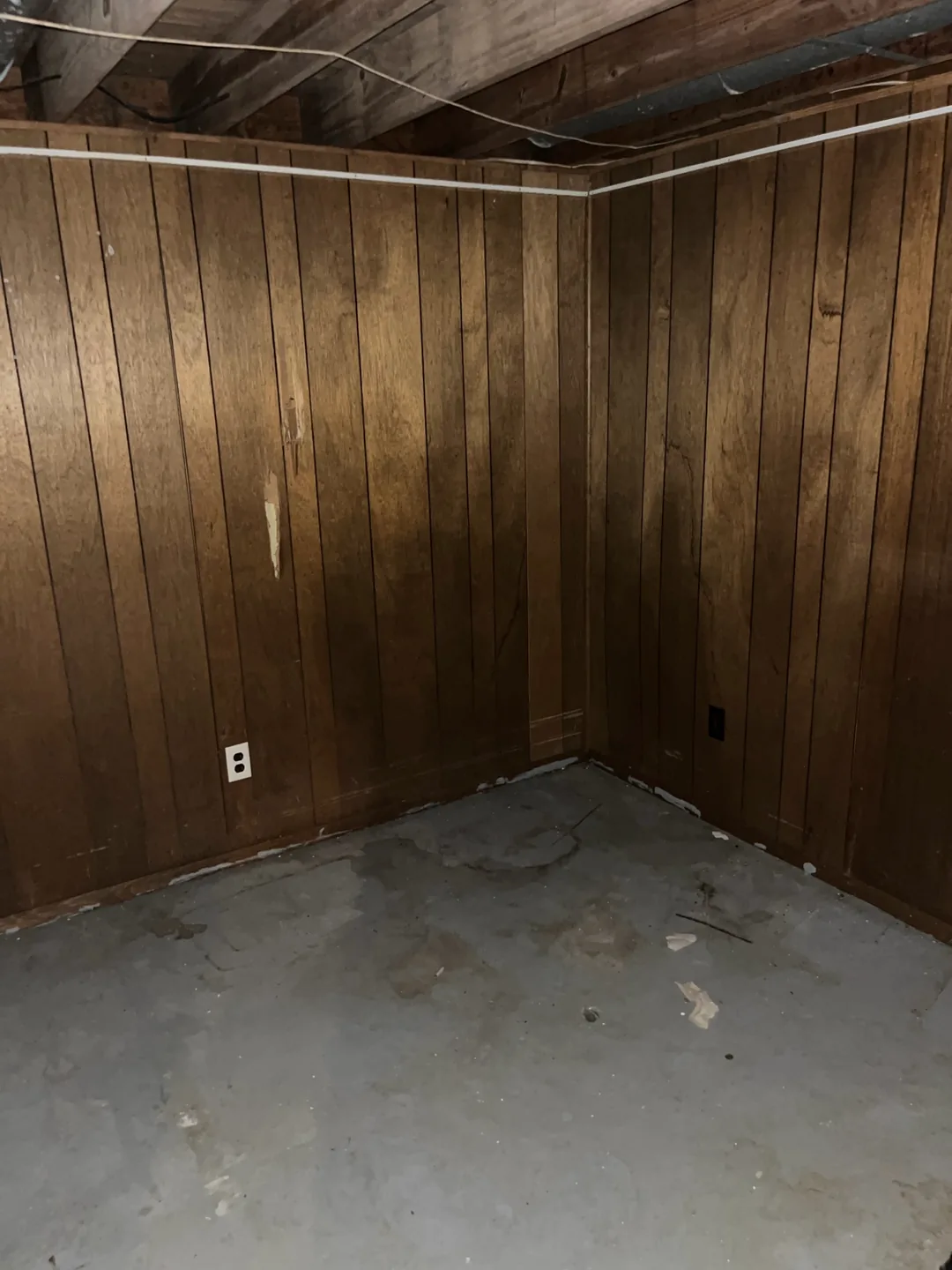 The same wood-paneled room cleared after the property cleanout