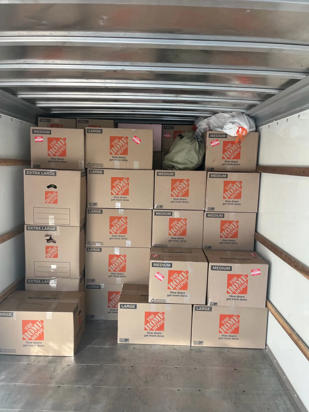 An organized load of boxes arranged inside a moving truck